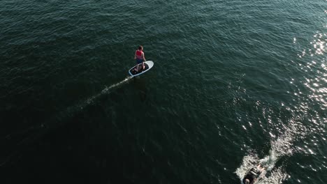 drone shot of someone cruising on an electric surfboard