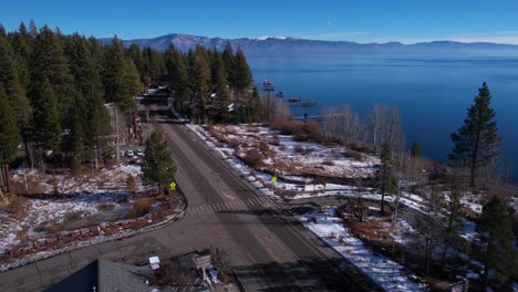 Lake-Tahoe-USA,-Aerial-View-of-Coastal-Road-and-Traffic-on-Sunny-Winter-Day