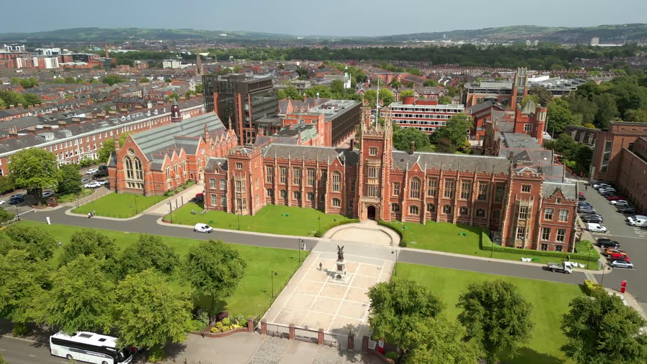 Wide, forward travelling aerial video of the campus at Queen's University Belfast, in Northern Ireland, UK on a bright and sunny day. Produced at 4K resolution, 60FPS and with Rec709 color.