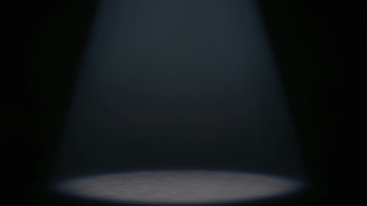 Tænder for overhead spotlight, der udvider strålen på en tom, mørk scene og danner en lyskegle til showet