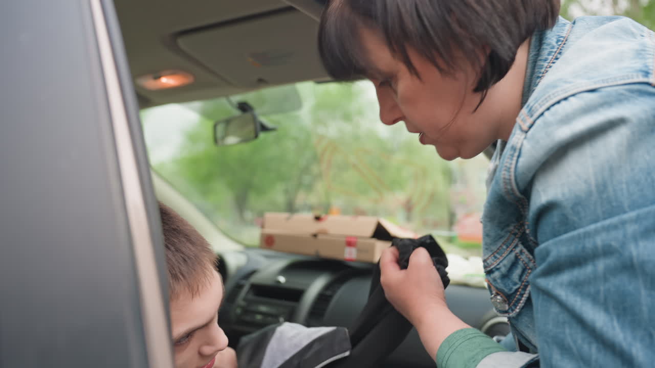 Female Protector Thoroughly Inspects Outer Garments For Safety Compliance, Guardian Meticulously Reviews Outerwear To Guarantee Security Standards Before Venturing Outside With Young Child