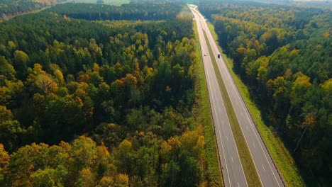 highway road in forest landscape. drone shot of asphalt road at autumn forest