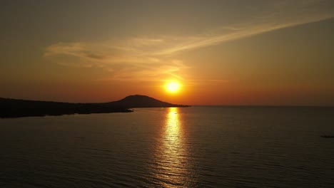 aerial dolly shot towards the beautiful orange sunset over lake victoria