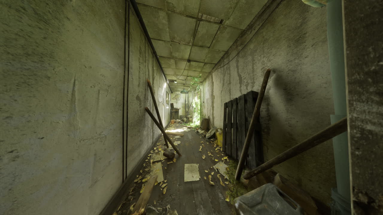 Abandoned corridor with overgrown foliage and debris in a neglected building