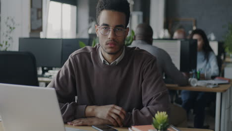 man sitting at a desk in an office