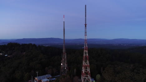 slow anticlockwise orbit around tv communications antenna during purple dusk evening