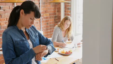 businesswoman using smartwatch 4k