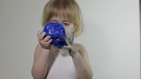 Child-having-fun-making-slime.-Kid-playing-with-hand-made-toy-slime.