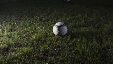 soccer ball on a grassy field at night