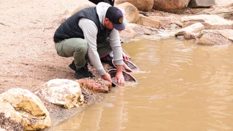 adults and children panning for gold together