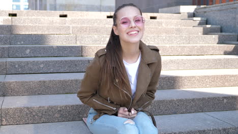 smiling woman sitting on steps