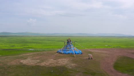 drone pulls back from colorful festive cultural art display on mongolia grassland