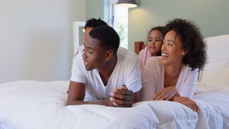 front view of black family having fun in bedroom in a comfortable home 4k