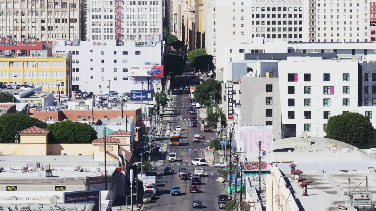 Aerial View of a Bustling City Street with Cars and Buildings
