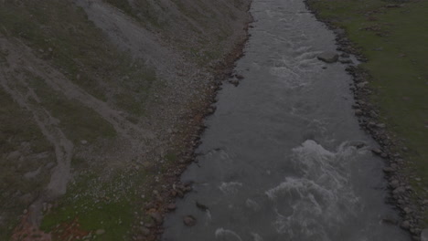 Aerial-establishing-shot-of-tourists-exploring-the-vast-mountain-range-within-Georgia