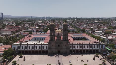 Drone-shot-Basilica-of-Our-Lady-of-Zapopan,-Guadalajara,-Mexico,-pulling-away