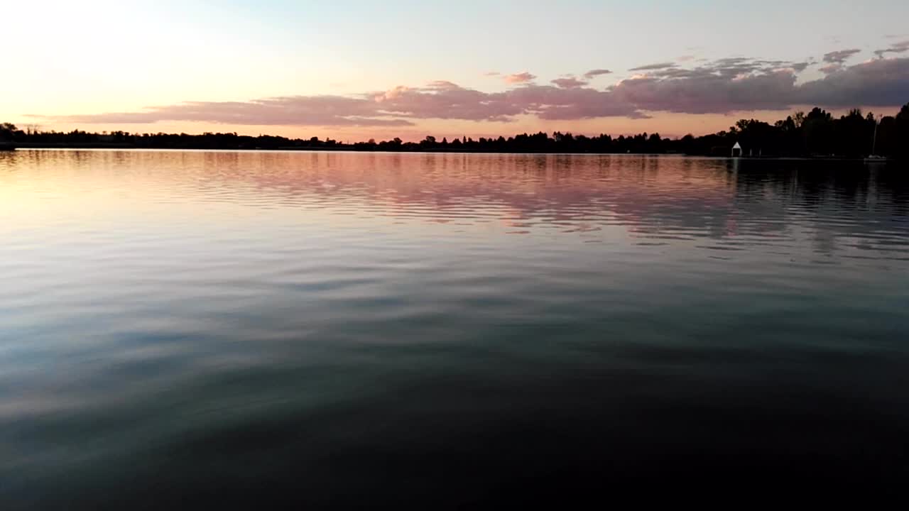 Sunset over a beautiful calm lake after day of fishing in Africa