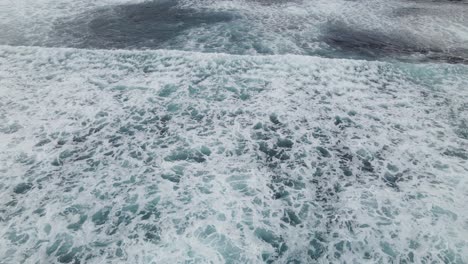 aerial flight over ocean waves crashing and ocean wash