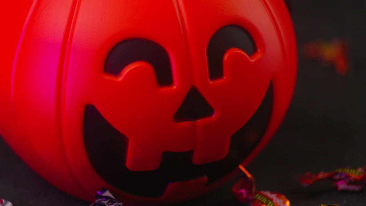 Close up shot of Halloween Pumpkin candy and thunder lights