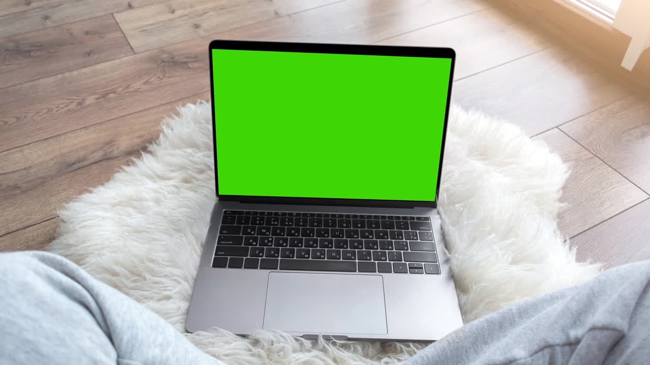 Green screen laptop computer sitting on a home work