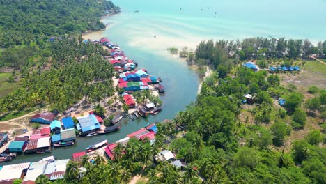 drone descends along estuary connection of river and ocean with homes built along riverbanks in koh rong island sihanoukville cambodia