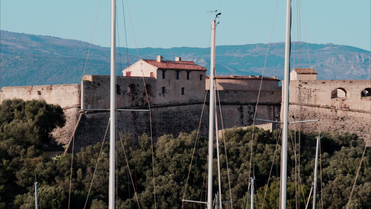 Boats docked in the Port Vauban with he Fort Carre on the background in Antibes, France