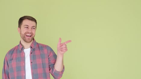 a handsome man in a shirt is posing pointing his index finger to the side a handsome man in a shirt is posing pointing his index finger to the side video