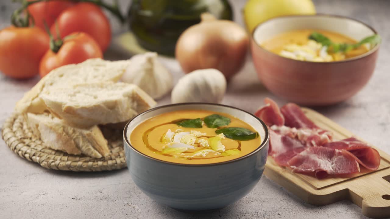 Eating salmorejo with bread and serrano ham