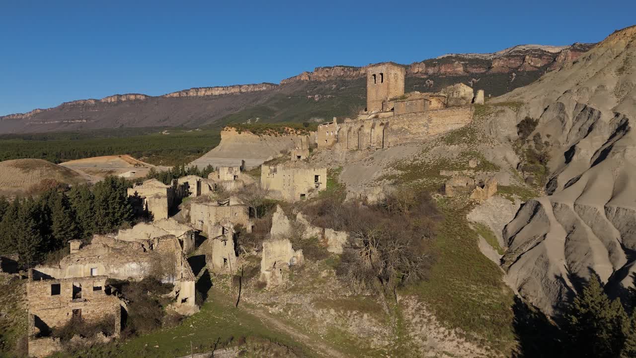 Moving forward drone movement to the abandoned village of Esc&oacute;, Spain and the mountains as a background