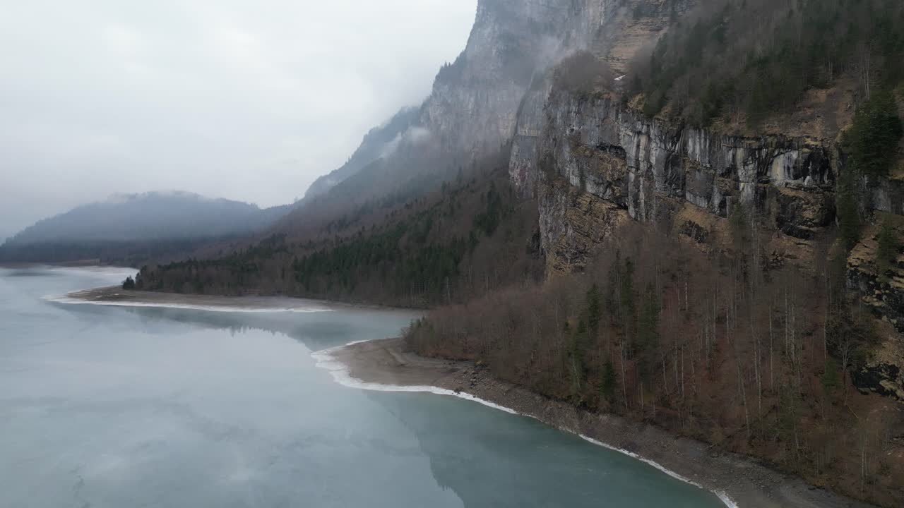 Klöntalersee Glarus Switzerland beautiful views of cliffs along misty lake beach