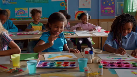 children happily painting in a vibrant classroom