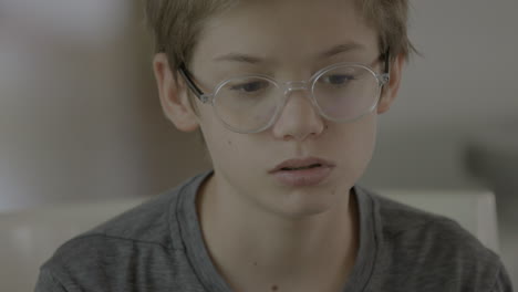 Closeup-portrait-of-a-teen-boy-at-home-while-in-a-virtual-class