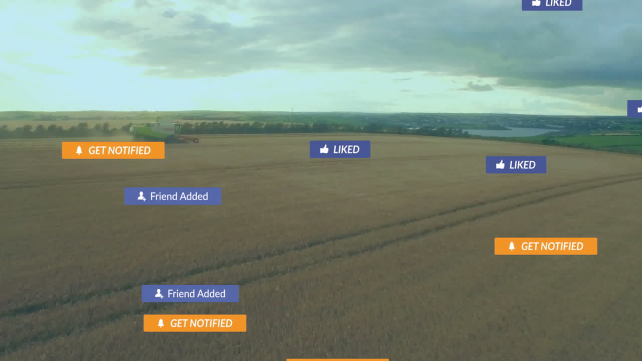 Combine harvester moving across golden wheat field, displaying social media notification icons