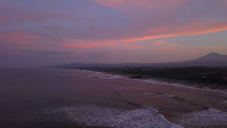 pink sky, purple ocean sunrise over kuta mandalika beach on lombok