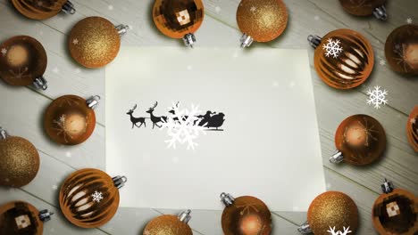 snowflakes over santa claus in sleigh being pulled by reindeers on a paper and multiple baubles