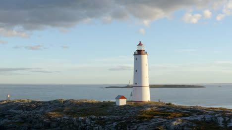 The-Beautiful-Lille-Torungen-Lighthouse-On-The-Island-Of-Lille-Torungen,-Arendal,-Norway---aerial-drone-shot