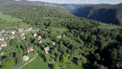 aerial of a typical village in the forest mountains in bosnia