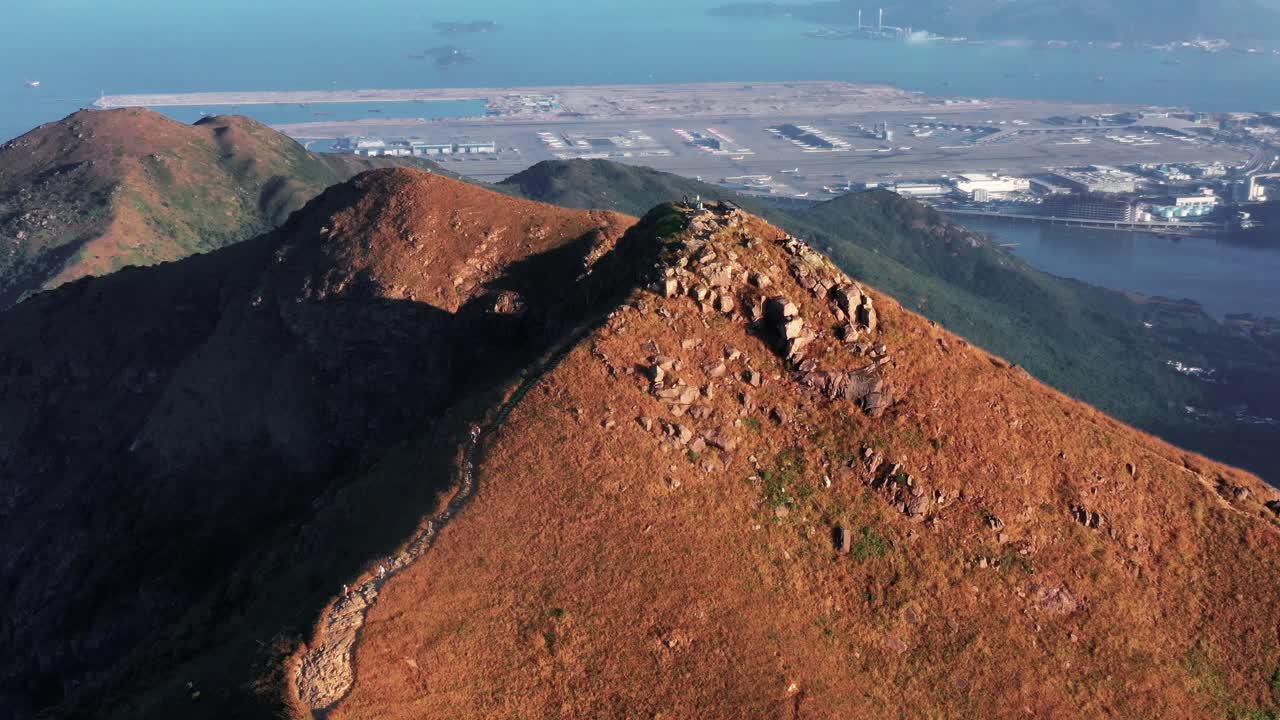 Sunset peak in Hong Kong.Mountain in sunset.Beautiful mountain. Mountain during the sunset time looking good in yellow sunshine.with sea in the background
