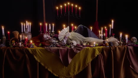 gothic renaissance tableau: woman surrounded by candles - vampire girl and beauty in red dress