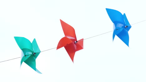 colourful plastic pinwheels rotate with blowing wind