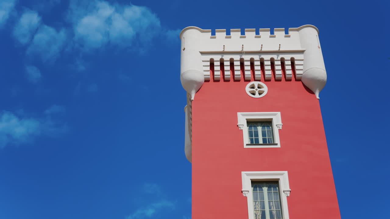 The red tower of the Cremat Castle Winery over the blue sky