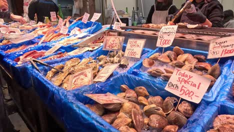 customers browsing assorted baked goods at a stall.