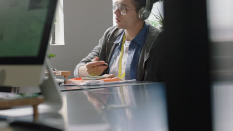 young caucasian businessman using computer typing browsing online research focused entrepreneur working in startup office brainstorming listening to music