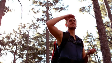 Man-hiking-through-a-forest