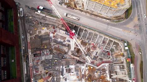 aerial shot of a bustling construction site with cranes and equipment