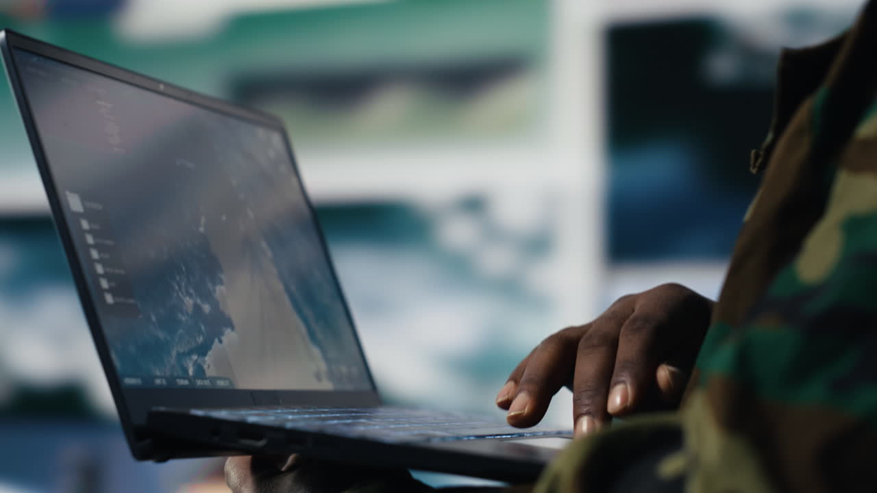 Armed forces soldier gathers surveillance from digital drone systems