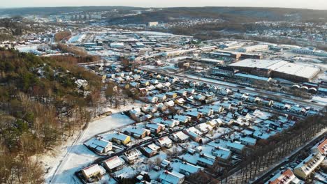 rows of houses and buildings in snowy village in the outskirts of gothenburg, sweden during winter