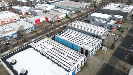 jib up of rooftops of industrial buildings covered in snow