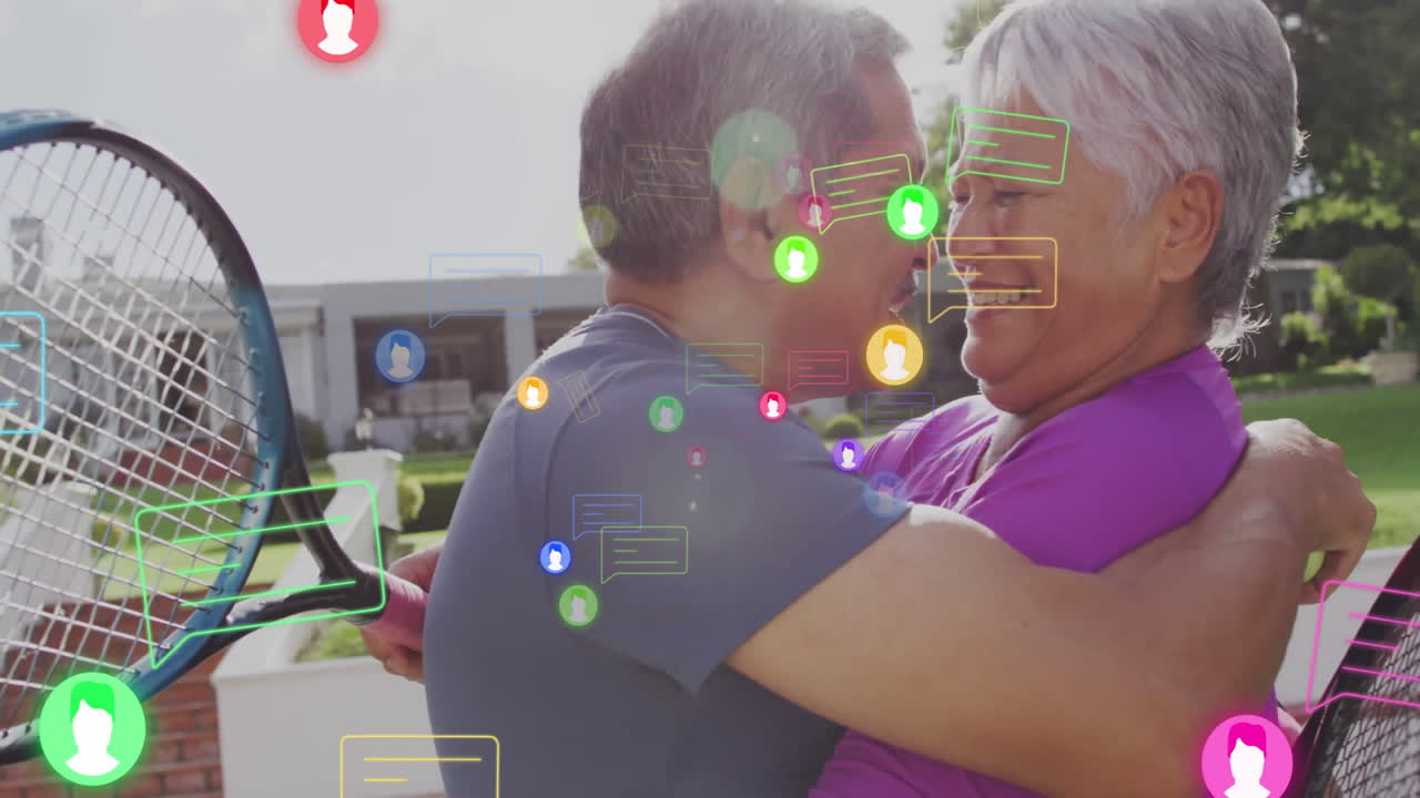 Senior couple hugging on court with rackets, showing messaging app with chat bubbles and user icons