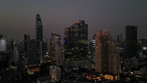 aerial drone footage of bangkok vibrant and dynamic central business district sathorn, bangkok city at night from above